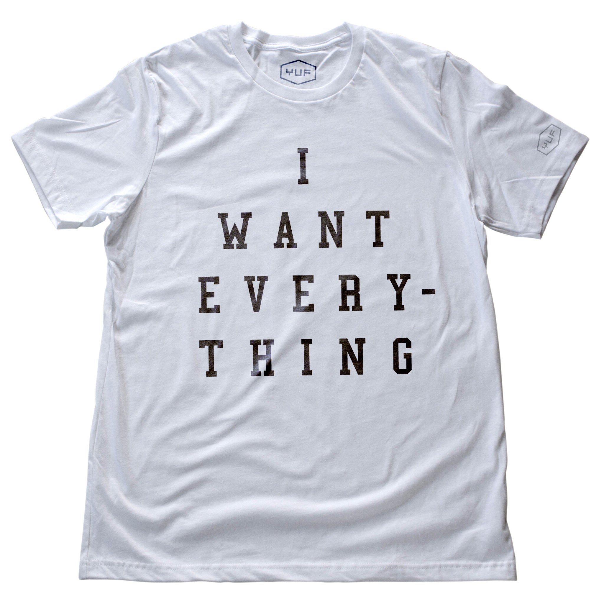 A simple, elegant, sarcastic retro graphic t-shirt in white, with bold typography that reads “I WANT EVERYTHING.” By fashion brand YUF, from wolfsaint.net