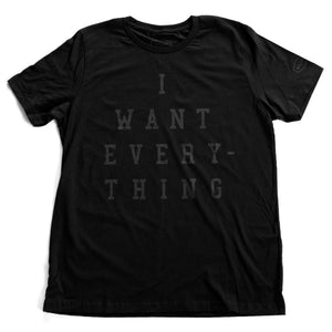 A simple, elegant, sarcastic retro graphic t-shirt in black, with bold typography that reads “I WANT EVERYTHING.” By fashion brand YUF, from wolfsaint.net