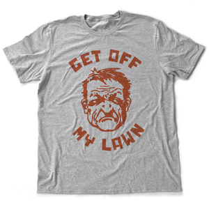 A sarcastic t-shirt in Athletic Heather Gray, inspired by the “Get Off My Lawn” meme, featuring a cartoonish angry man and bold typography. From fashion brand YUF, available at wolfsaint.net