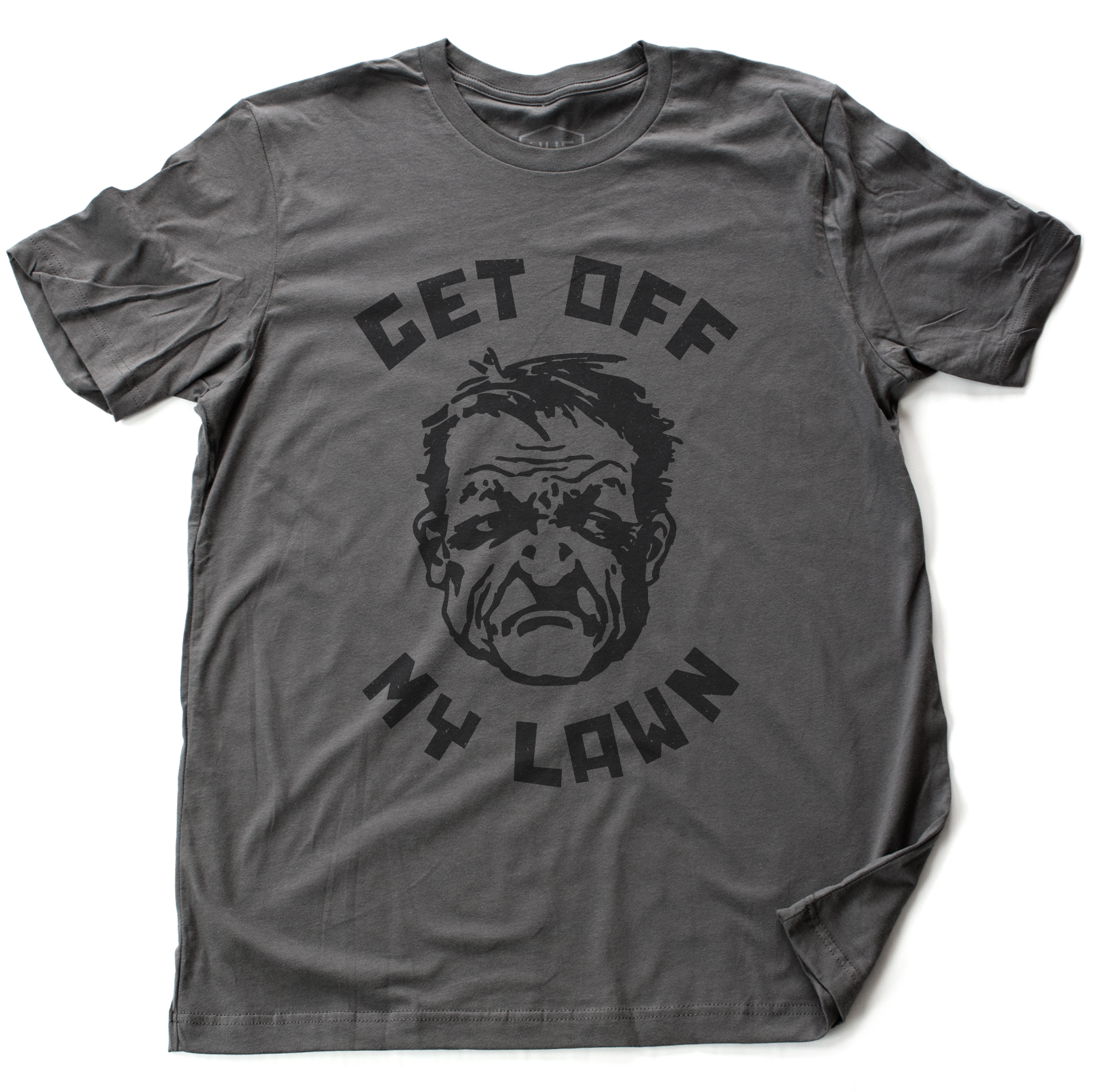 A sarcastic t-shirt in asphalt gray, inspired by the “Get Off My Lawn” meme, featuring a cartoonish angry man and bold typography. From fashion brand YUF, available at wolfsaint.net