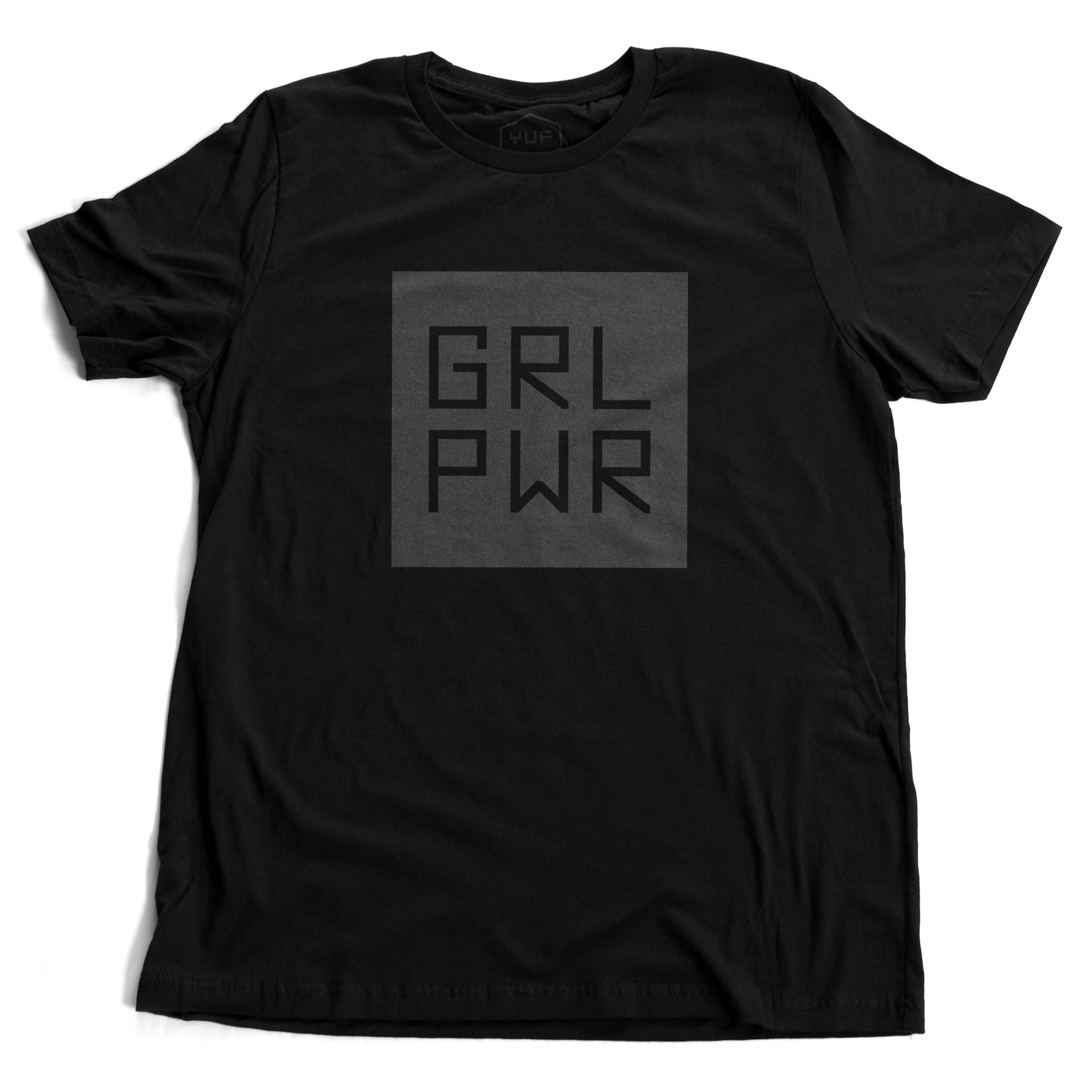 A black unisex t-shirt with a bold graphic representing “Girl Power,” abbreviated as GRL PWR. By fashion brand YUF, from wolfsaint.net