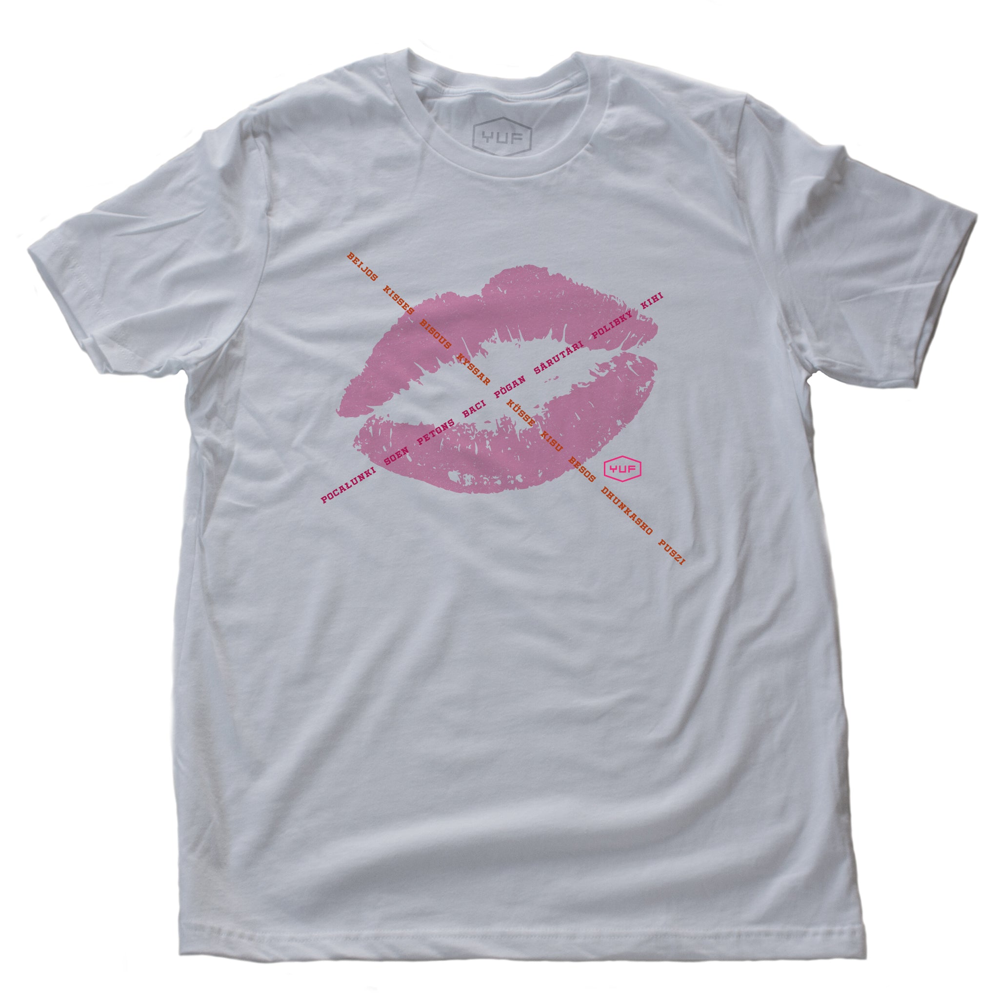 A unisex fashion t-shirt in white, featuring a lipstick kiss graphic, criss-crossed by the word for “kiss” in various languages. A classic icon reminiscent of Marilyn Monroe’s signature mark. By fashion brand YUF, from wolfsaint.net