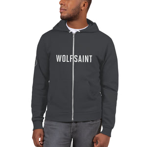A male model in a white studio wearing a fashionable, trendy Gray zippered hoodie sweatshirt with the WOLFSAINT gothic logo in white across the chest and the “W” circle crest on the right sleeve. From fashion brand wolfsaint.net