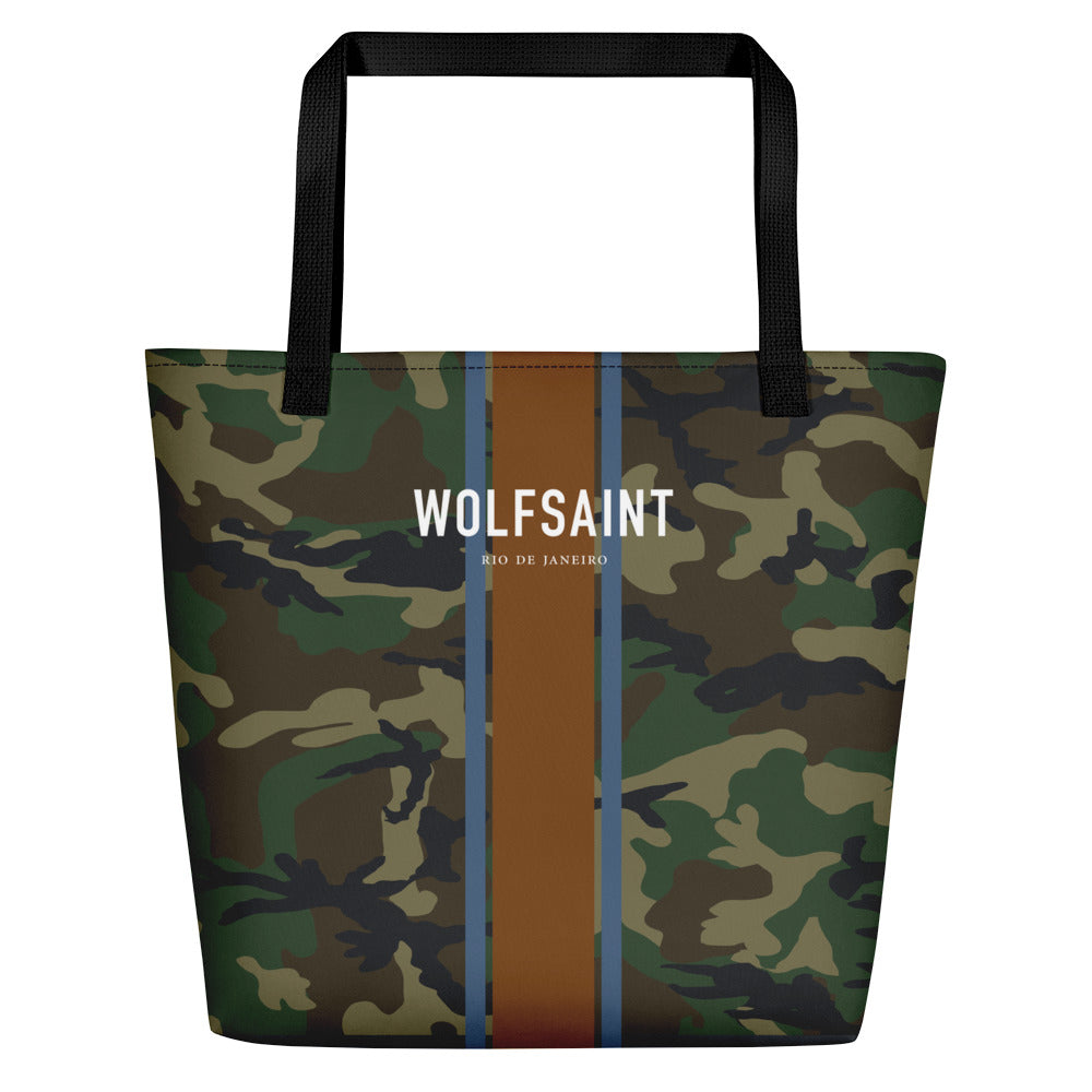 A elegant fashion-branded beach or city tote bag with a camo camouflage all-over pattern, and Solid vertical bands with the WOLFSAINT gothic logo and “Rio de Janeiro” in small type horizontally across it. From Wolfsaint.net