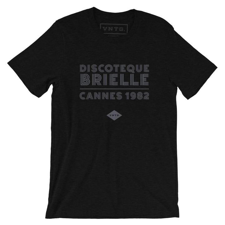 A fashionable classic black graphic tee, for a fictional Cannes, France disco from 1982. The retro typography reads “DISCOTEQUE BRIELLE / CANNES 1982” with the VNTG. diamond logo beneath. From Wolfsaint.net
