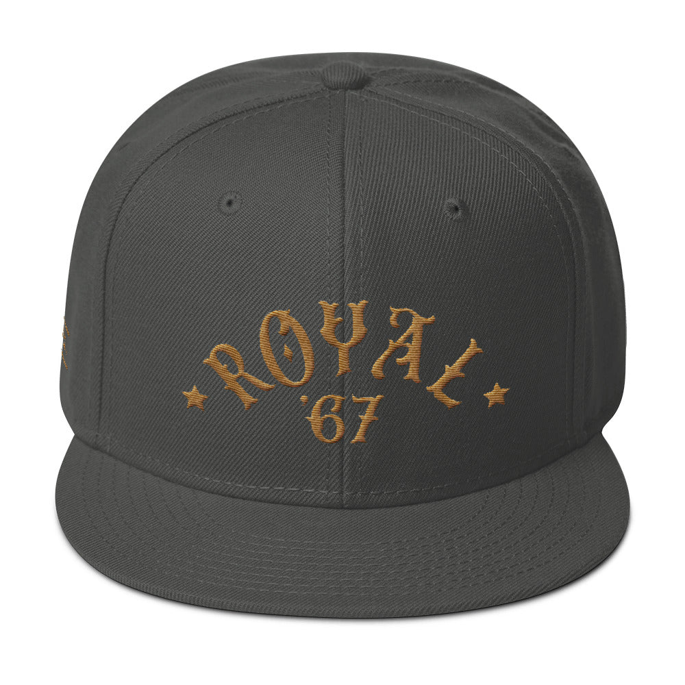 A retro gray SnapBack cap with “ROYAL” in classic vintage typography embroidered in an arc above the year ‘67. For Wolfsaint.net