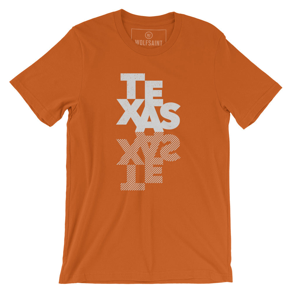 A fashionable graphic t-shirt featuring a custom designs typographic treatment of the word “TEXAS” and its inverted cross hatched mirror. By fashion brand WOLFSAINT, from Wolfsaint.net