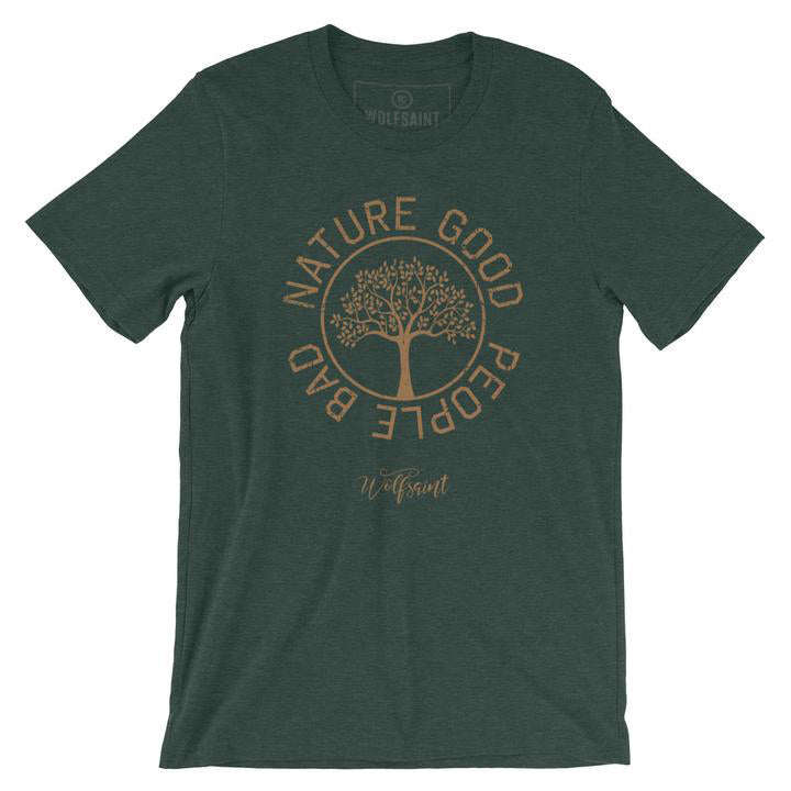 A fashionable vintage-inspired, retro t-shirt in Heather Forest Green, featuring a graphic of a thriving tree in a circle, surrounded by the sarcastic text: “NATURE GOOD, PEOPLE BAD” with the Wolfsaint brand script logo beneath. From wolfsaint.net