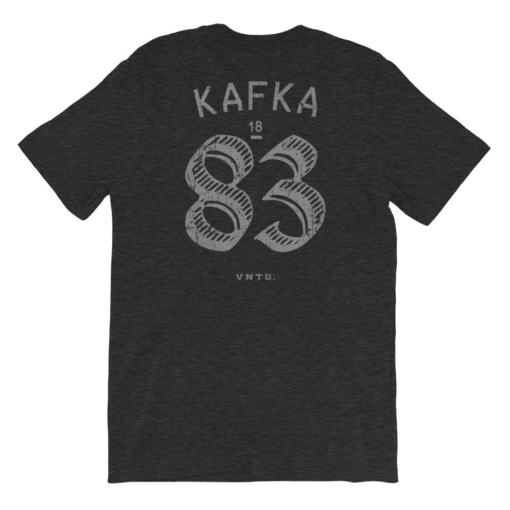 A vintage-inspired retro t-shirt in a mock athletic style, with a sarcastic nod to liberal arts college. This shirt, in Classic Dark Gray Heather, features the name Of the author KAFKA and his birth year 1883 on the back. By fashion brand VNTG., from wolfsaint.net