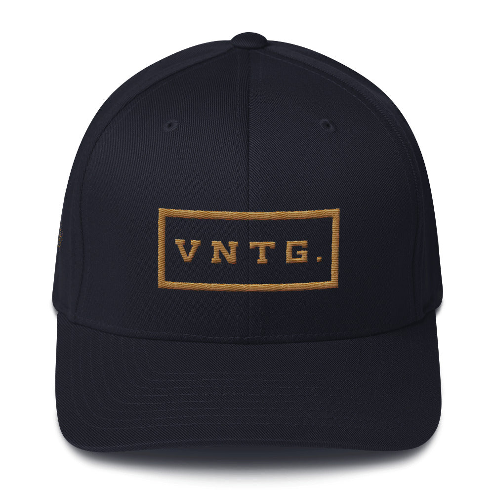 A classic baseball cap in navy blue, with the VNTG. brand logo embroidered in gold thread. VNTG. represents many things. Vintage cars, guitars, watches, motorcycles, antiques, wine, clothes, furniture... From wolfsaint.net